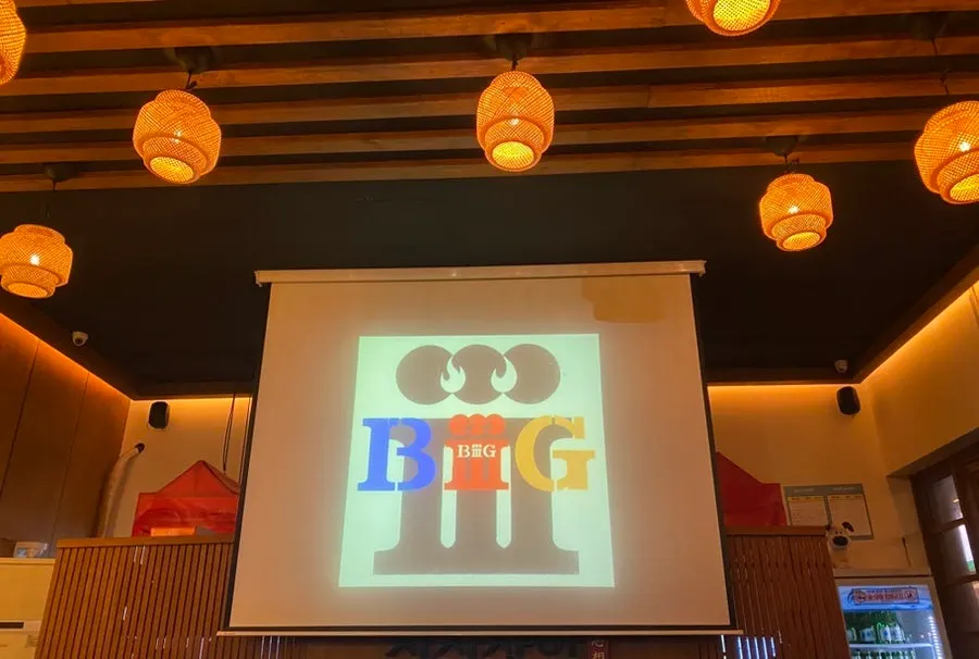Large screen displaying the song request in the restaurant