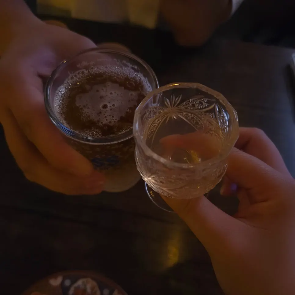Table with plum wonju and non-alcoholic beer
