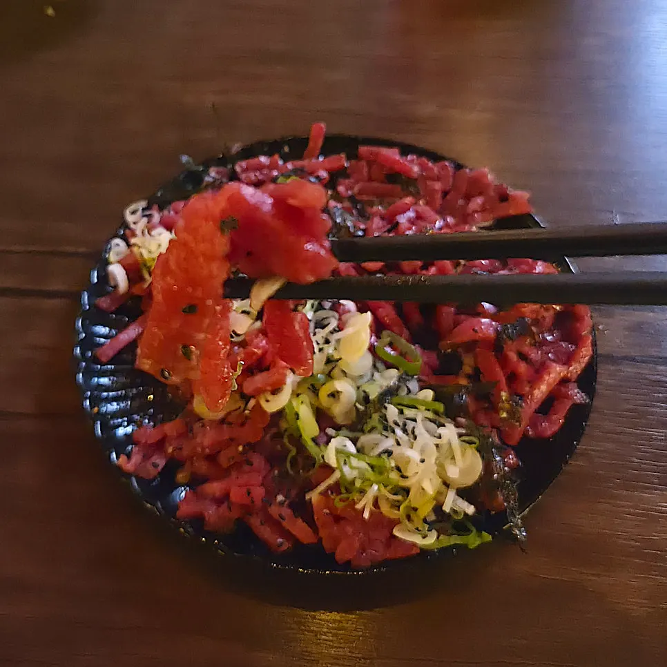 Plate of yukhoe topped with an egg yolk