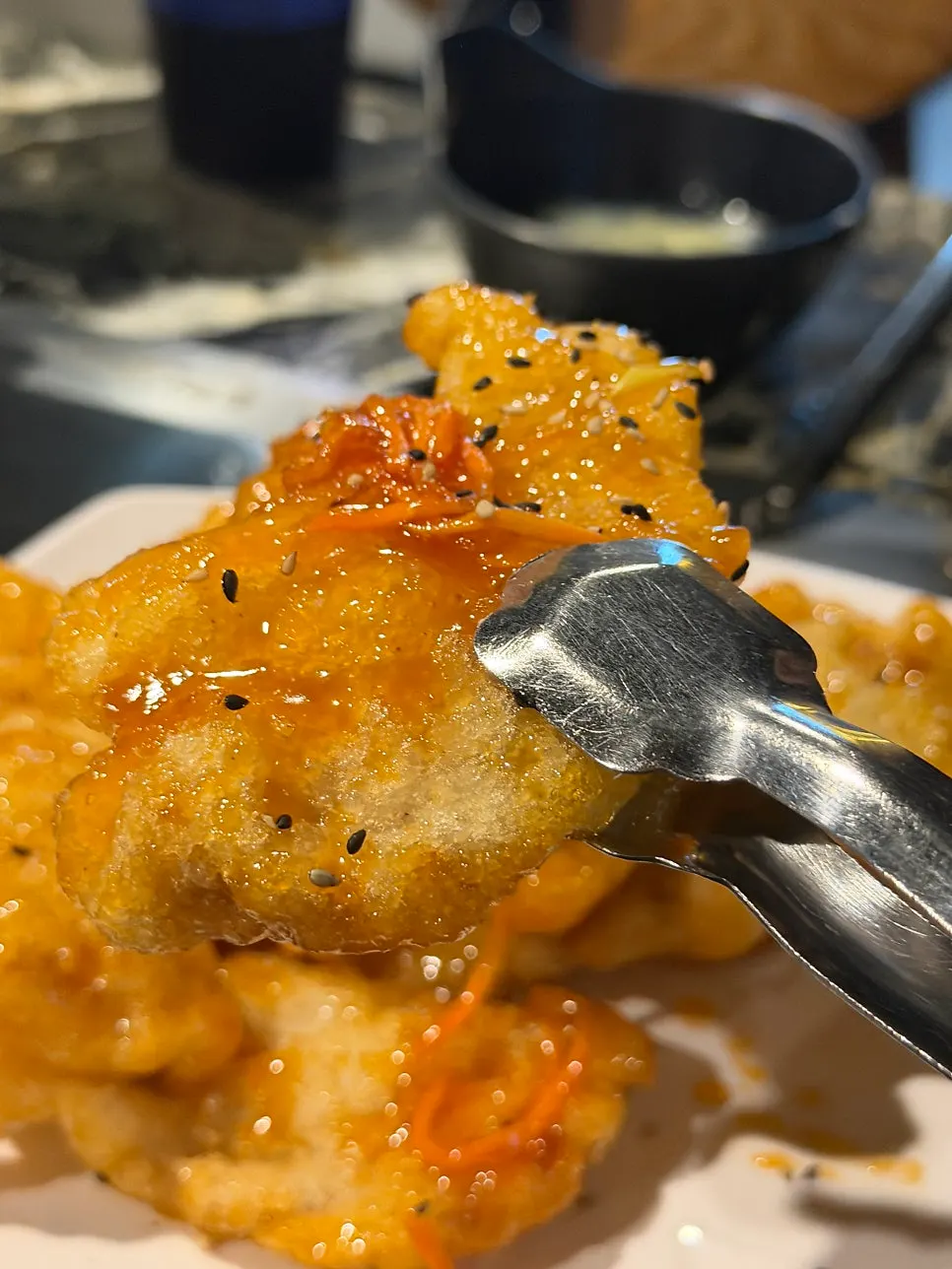 A piece of guobaorou coated in sauce