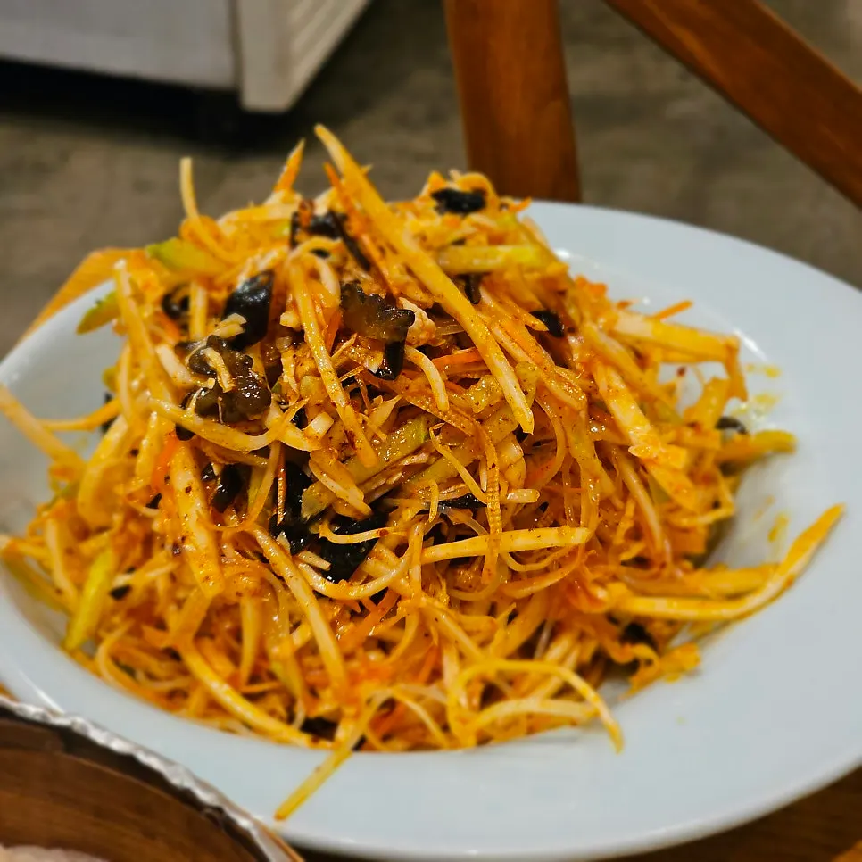 A plate of tangy cold salad with tofu skin and vegetables