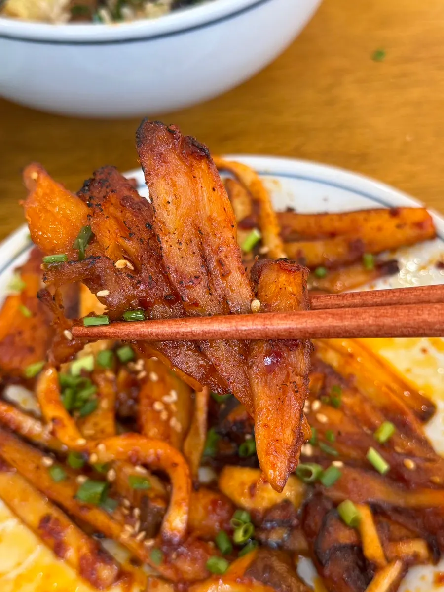 Close-up of grilled deodeok with mushrooms showing smoky char