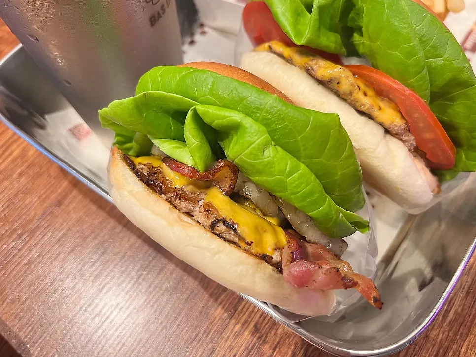 Table with burgers, fries, and sauces
