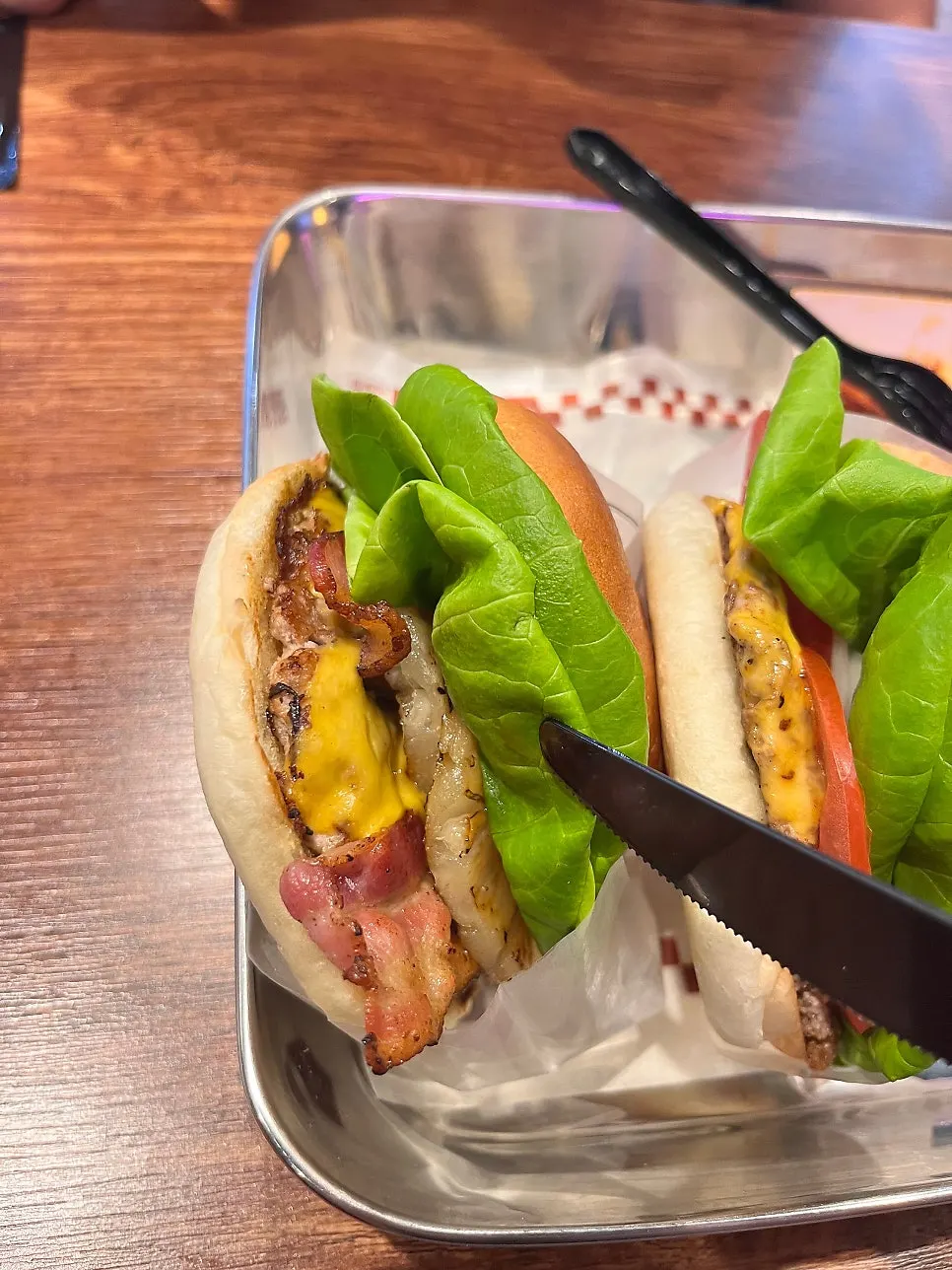 A bite taken out of the Bas Burger showing patty and vegetables