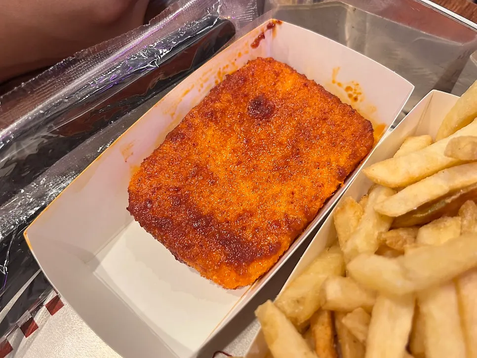 Thick fries dipped in ranch sauce