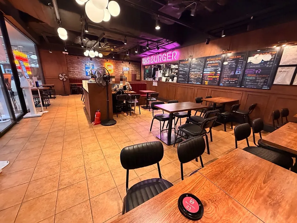 A full spread of Bas Burger, milkshake, buffalo chicken wings, and coleslaw