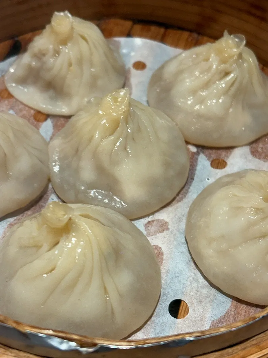 A xiaolongbao placed on a spoon