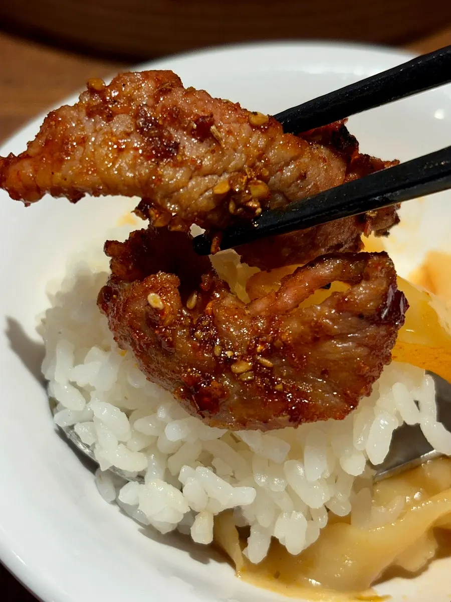 Cumin beef placed on top of rice