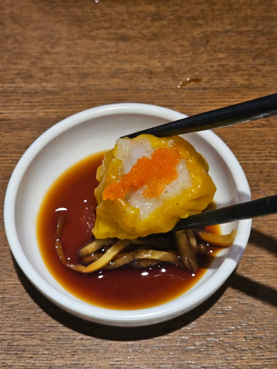Shumai with yellow wrapper packed full of shrimp and meat filling