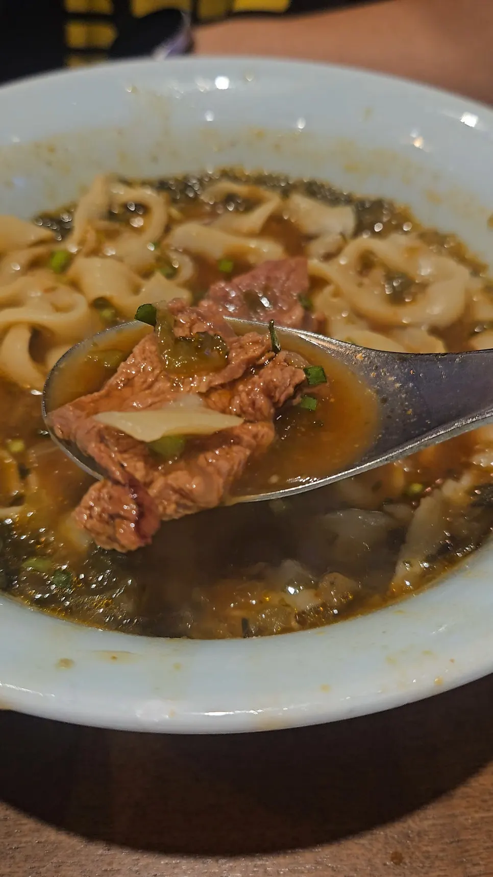 Uneven-thickness knife-cut noodles lifted with chopsticks