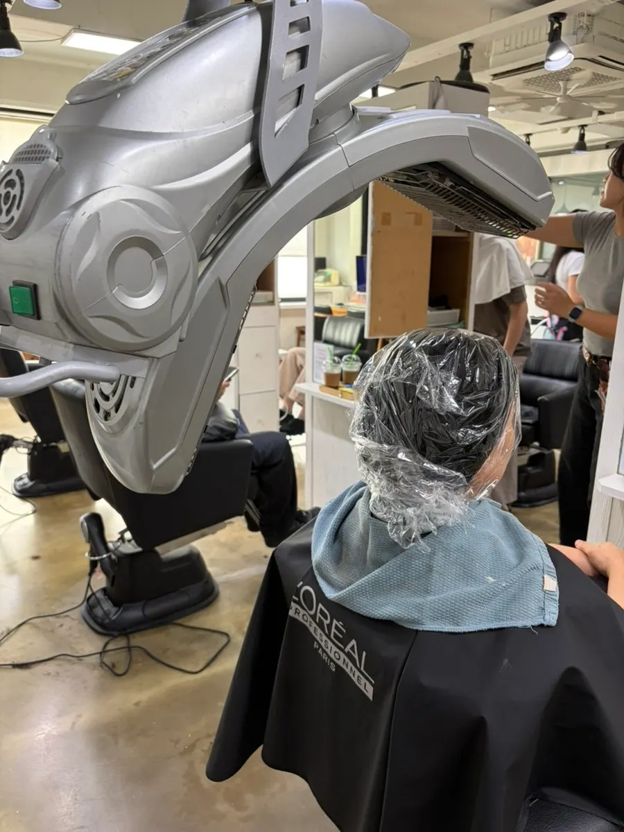Two designers rolling and caring for the hair
