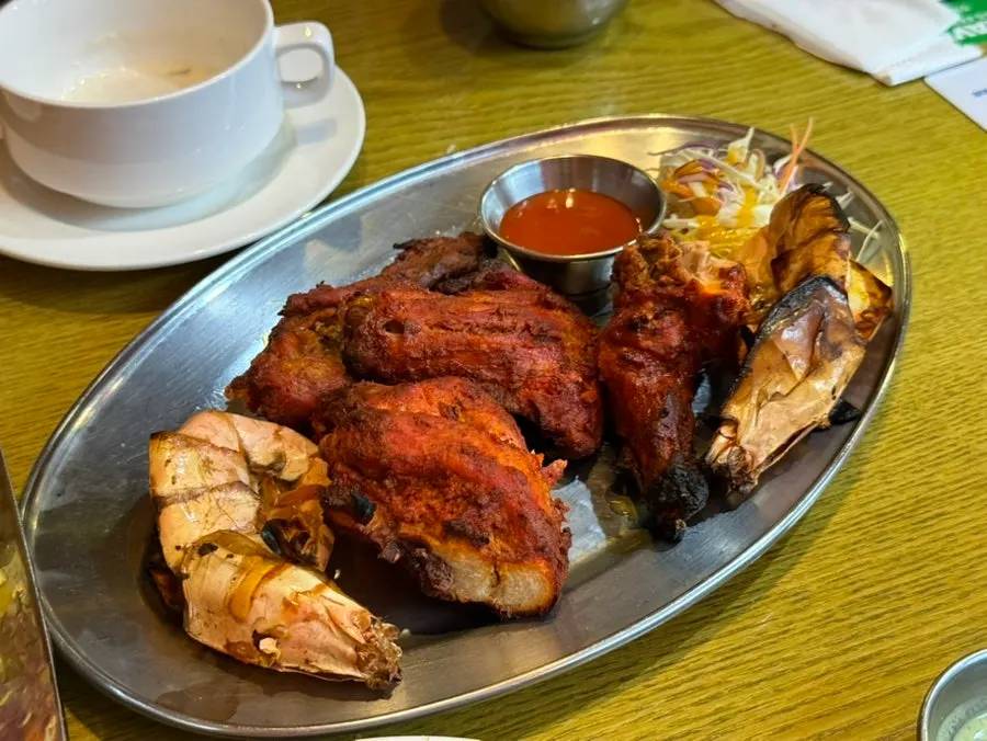 Plate of grilled king prawns and tandoori chicken