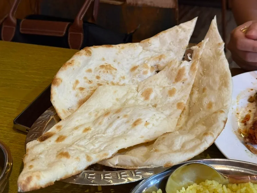 Garlic naan served alongside the curry