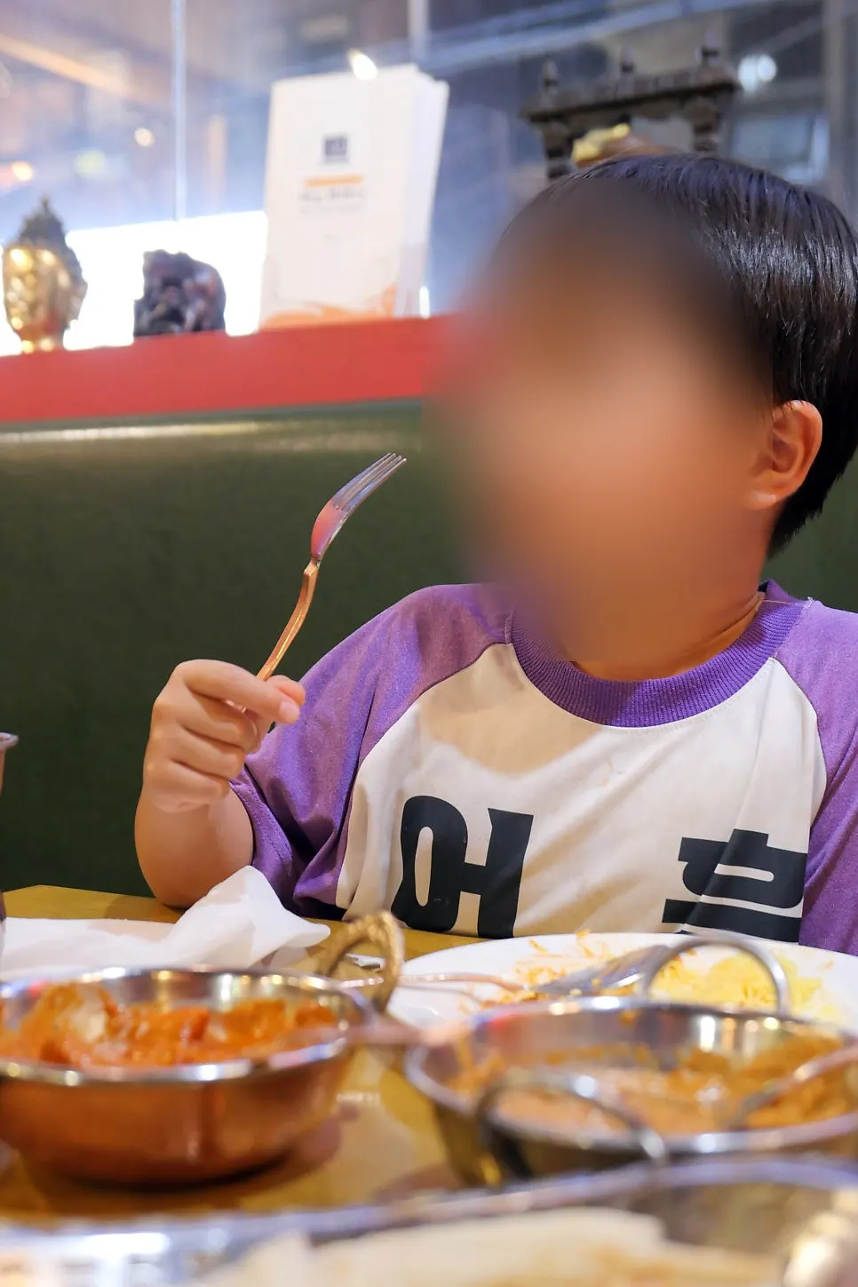 A child eating Indian curry