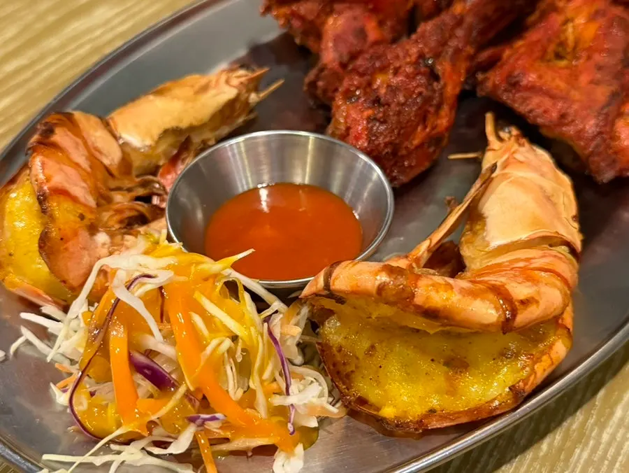 Tandoori chicken and king prawns cooked in a clay oven