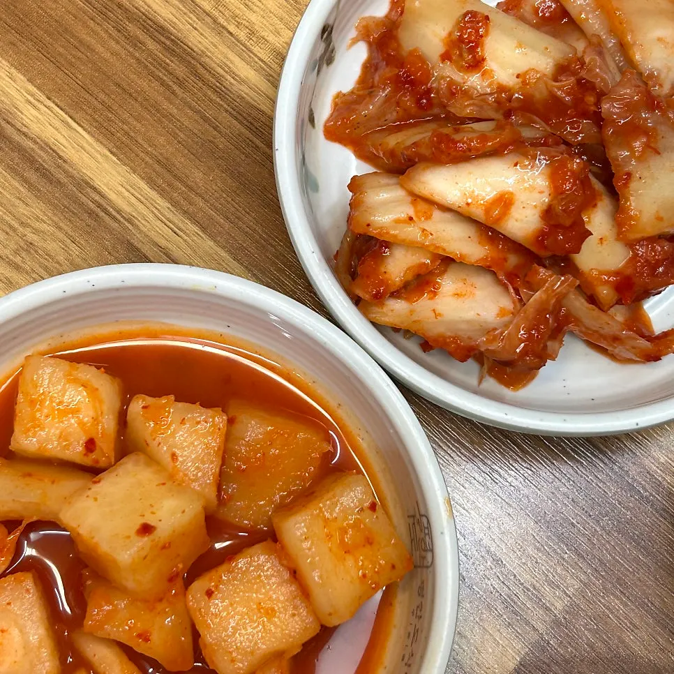 Basic side dishes including diced radish kimchi and cabbage kimchi
