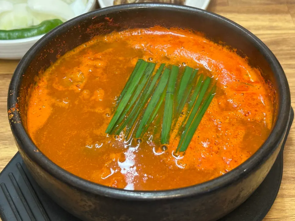 A bowl of spicy sunsal-guk with a fiery broth