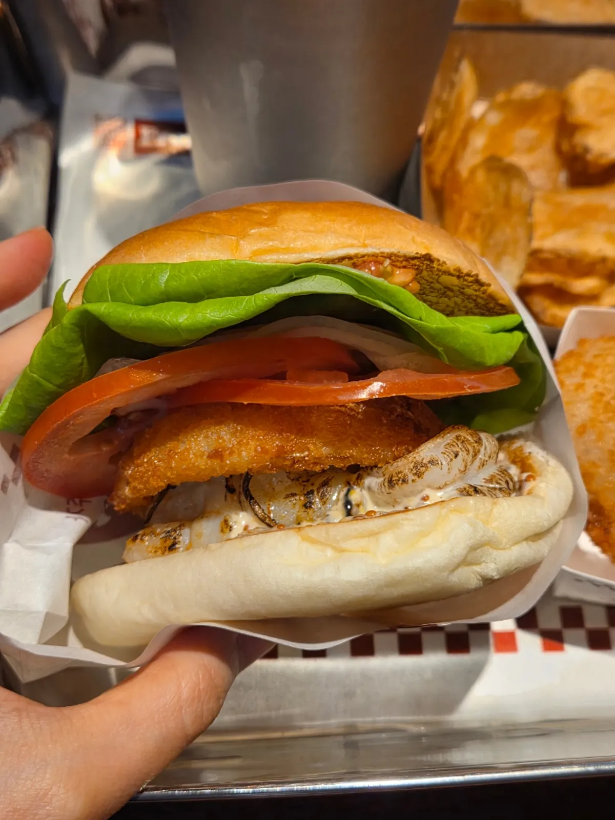Wasabi mayo shrimp burger with onion rings and a milkshake