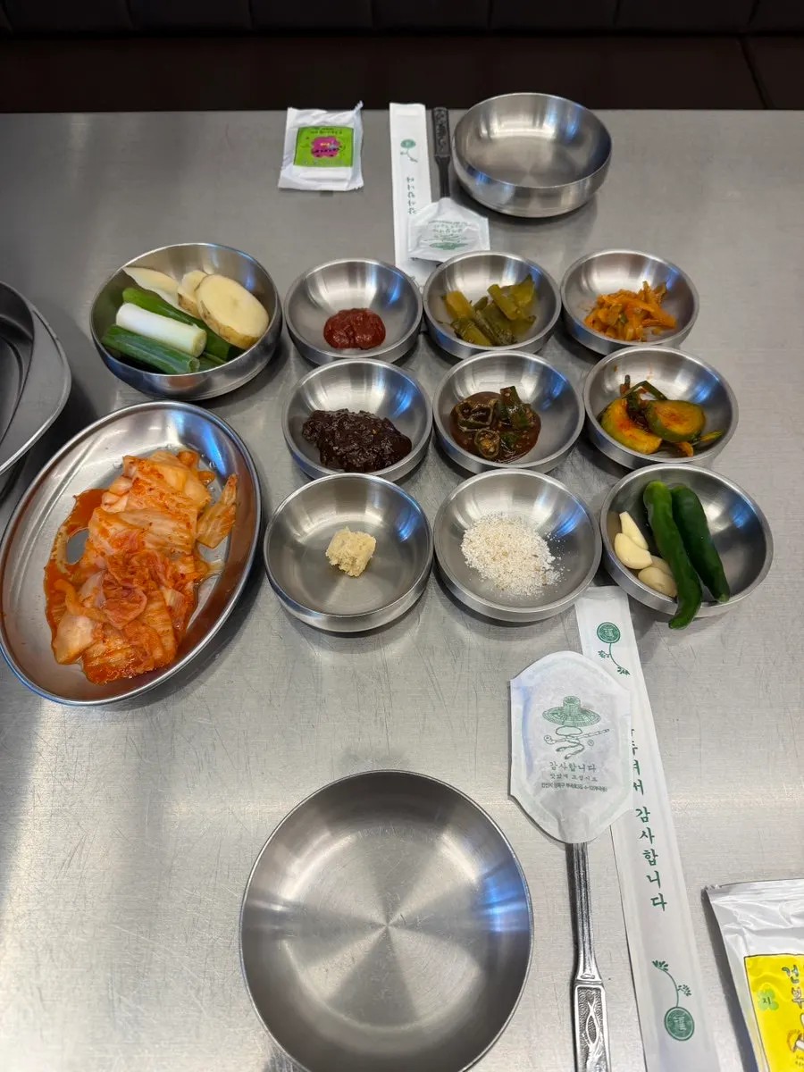Kimchi, potatoes, green onions, and pickled side dishes spread