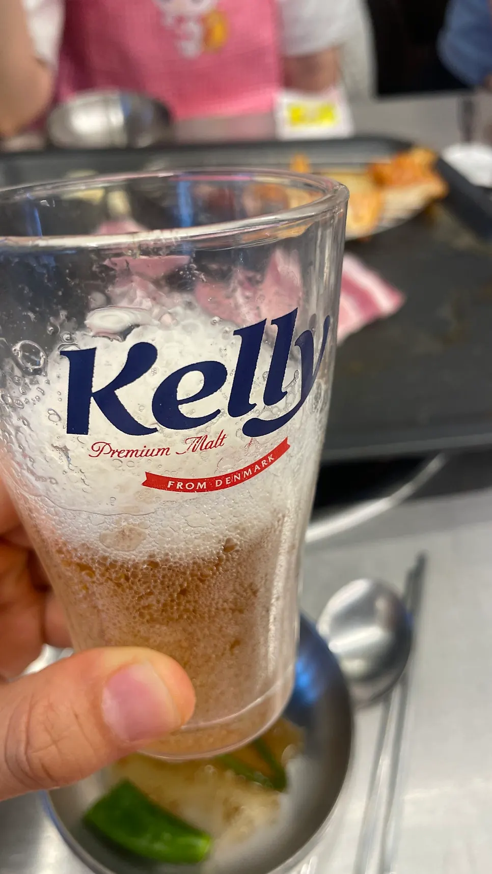 A cold glass of beer alongside the grilled meat