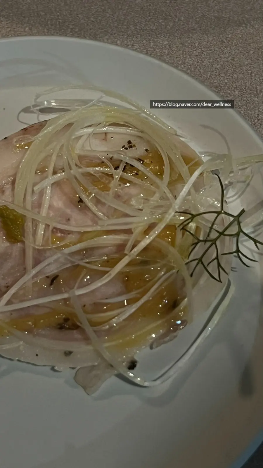 Close-up of black pork carpaccio with green sauce