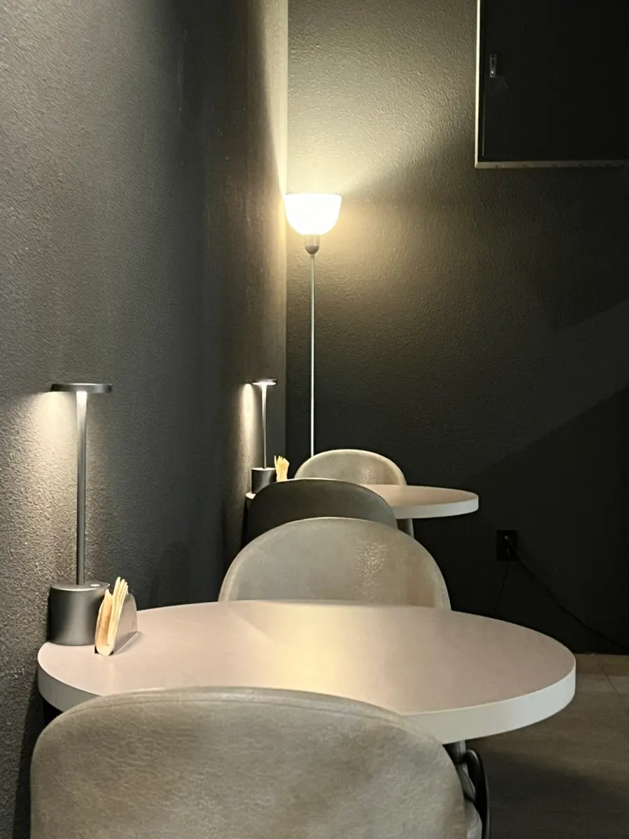 Plot's interior with black walls and gray tables