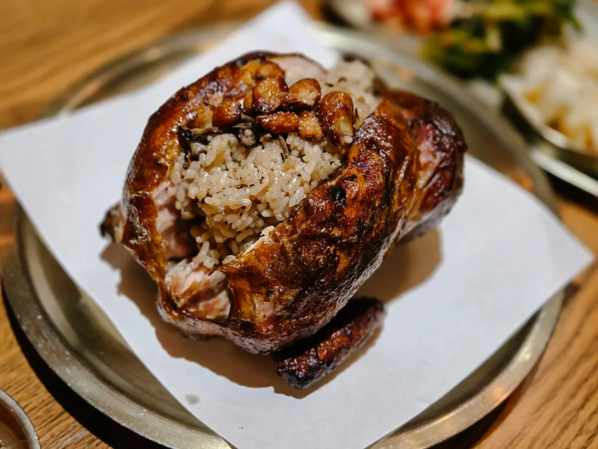 Signature photo of Gyeryugwan's oak-fired neungi mushroom chicken in Sindang