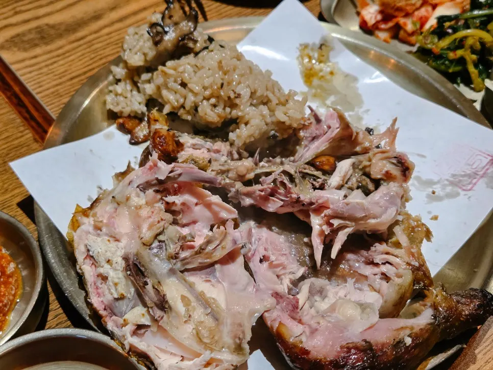 Neungi mushroom sticky rice inside the split-open whole chicken