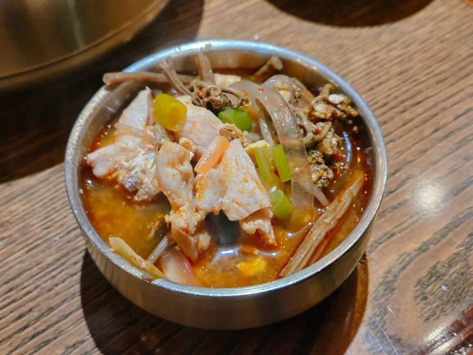 A spoonful of the spicy dakgaejang broth lifted up