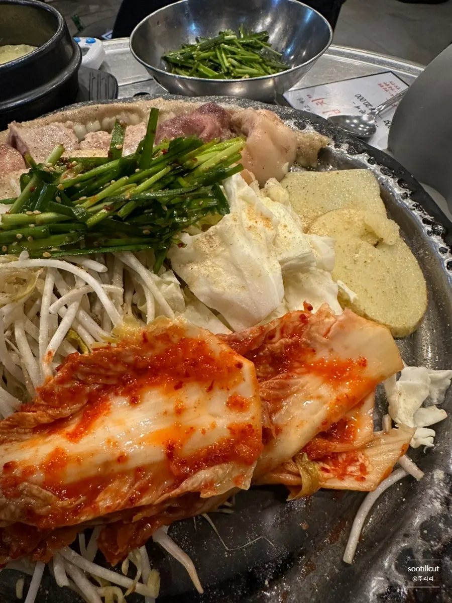 A pan of gopchang grilling with vegetables