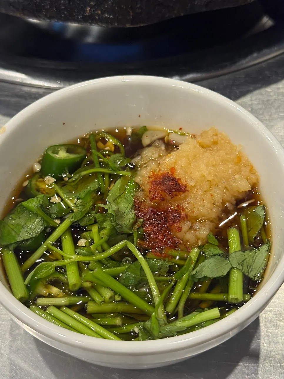 Gopchang sauce with minari and minced garlic