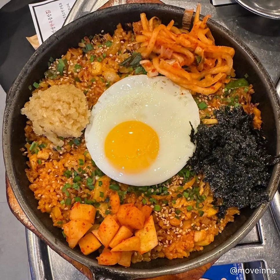 Kkakdugi fried tripe rice topped with a soft-fried egg