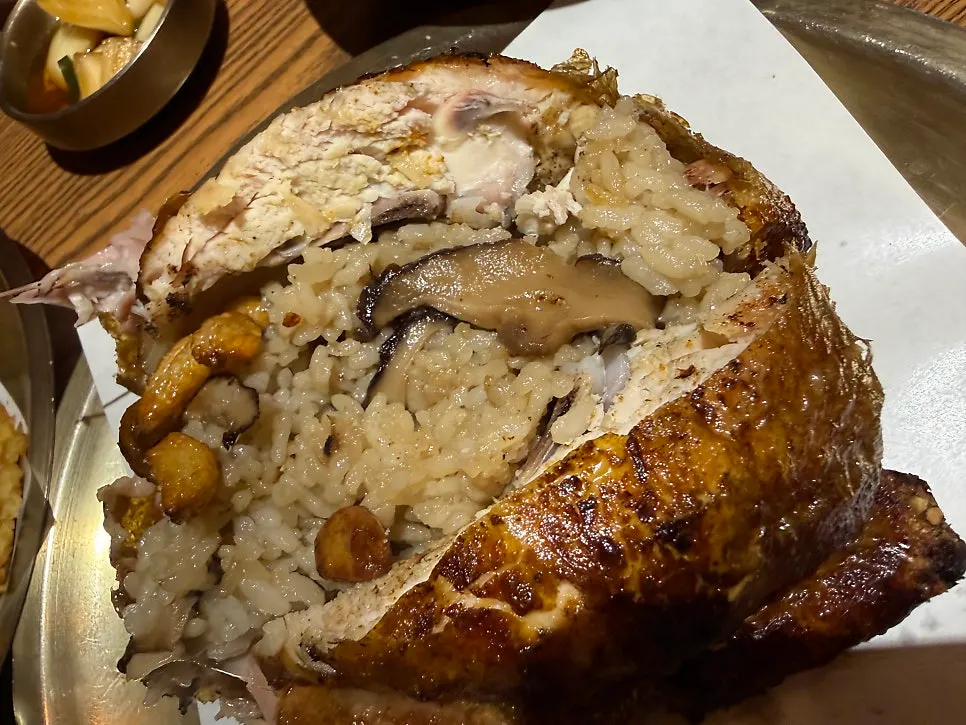 A plate served with portions of the oak-fired chicken and sticky rice