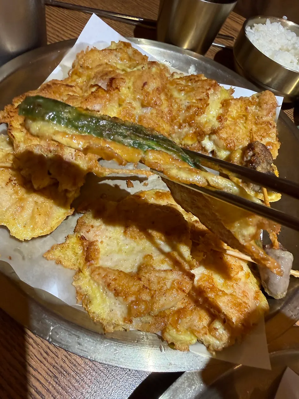 Picking up a piece of the assorted chicken jeon