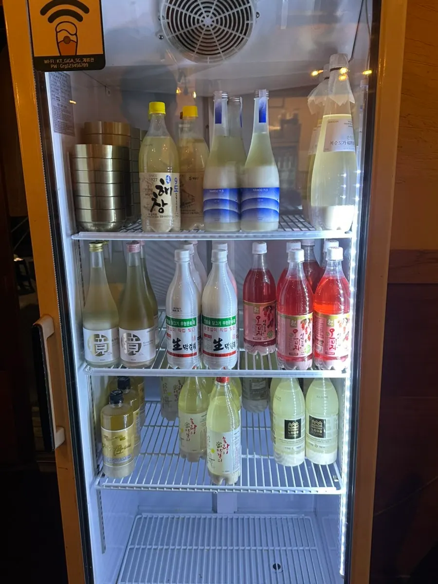 Fridge stocked with various types of makgeolli