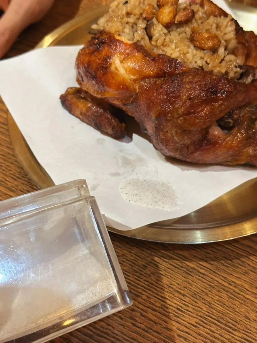 A small dish of salt beside the wood-fired chicken