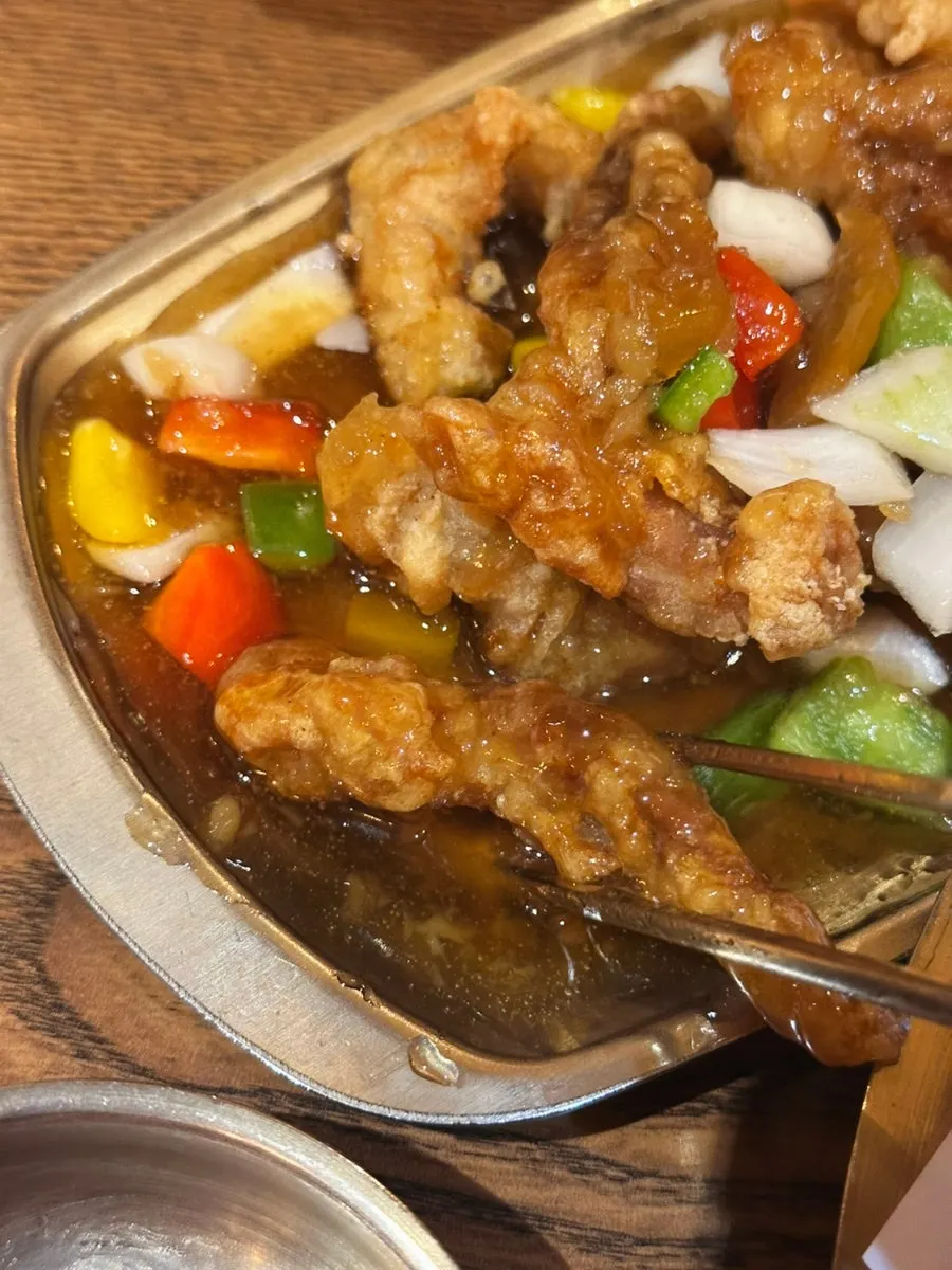 Close-up of chicken neck tangsuyuk coated in sauce