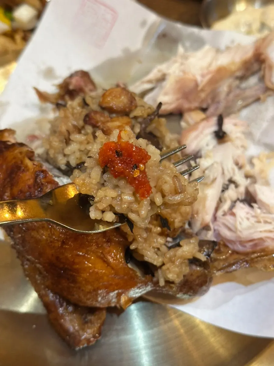 Kimchi and seasoned fish roe piled on rice from the oak-fired chicken