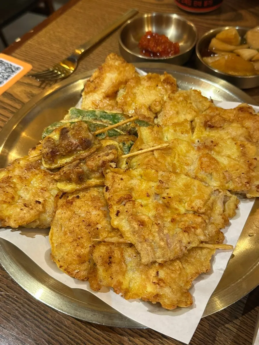 A plate of assorted chicken jeon with various parts