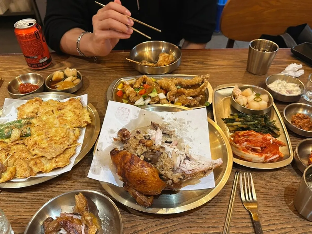Spread of oak-fired chicken, tangsuyuk, and assorted jeon on the table