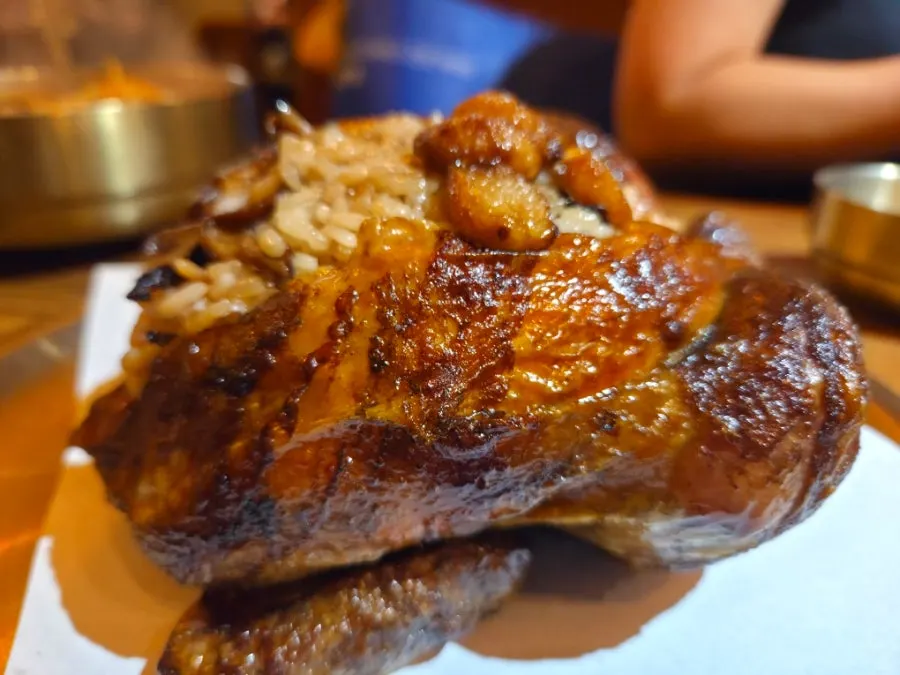 The glossy brown skin of the oak-fired chicken