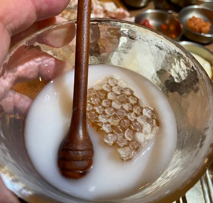 Gyeryugwan makgeolli served in a kettle alongside honeycomb