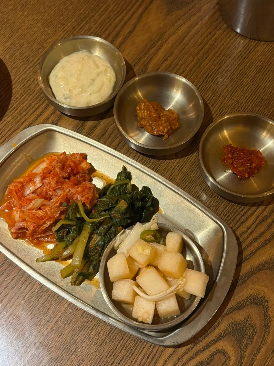 A spread of basic side dishes: diced radish kimchi, cabbage kimchi, and ssamjang