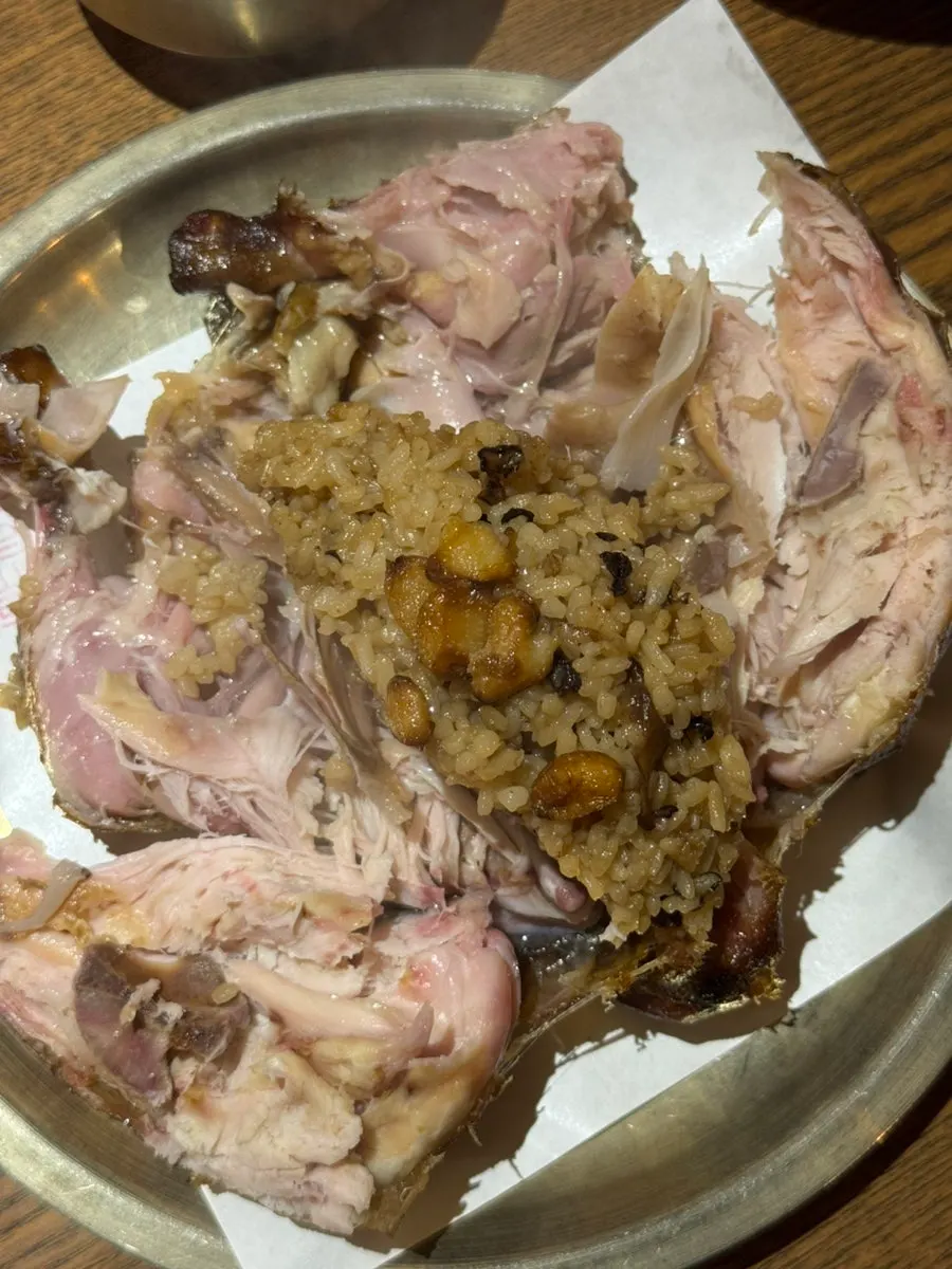 Golden brown exterior of the firewood-roasted chicken