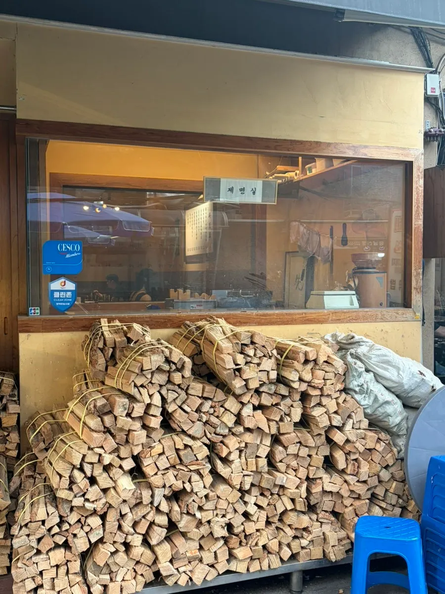 Tall pile of firewood stacked outside the restaurant