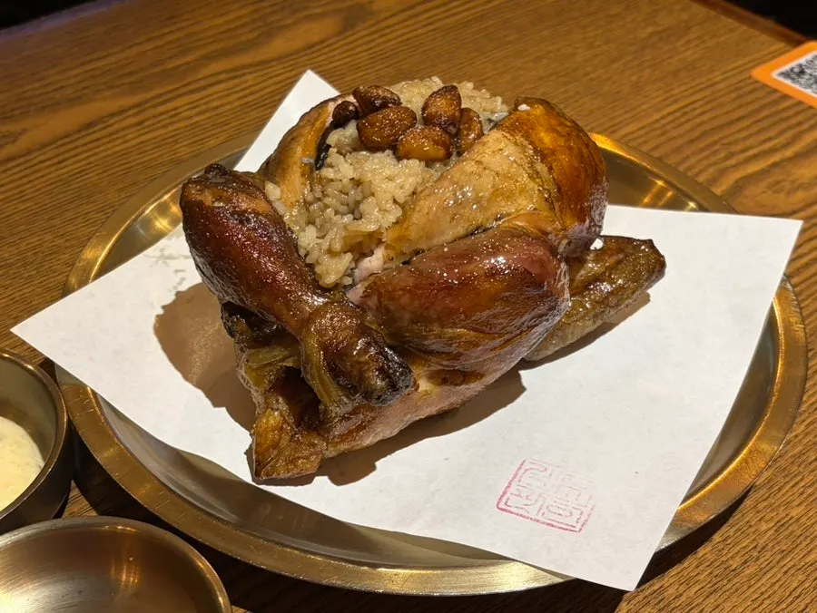 Table setting with the sticky rice-stuffed wood-fired chicken