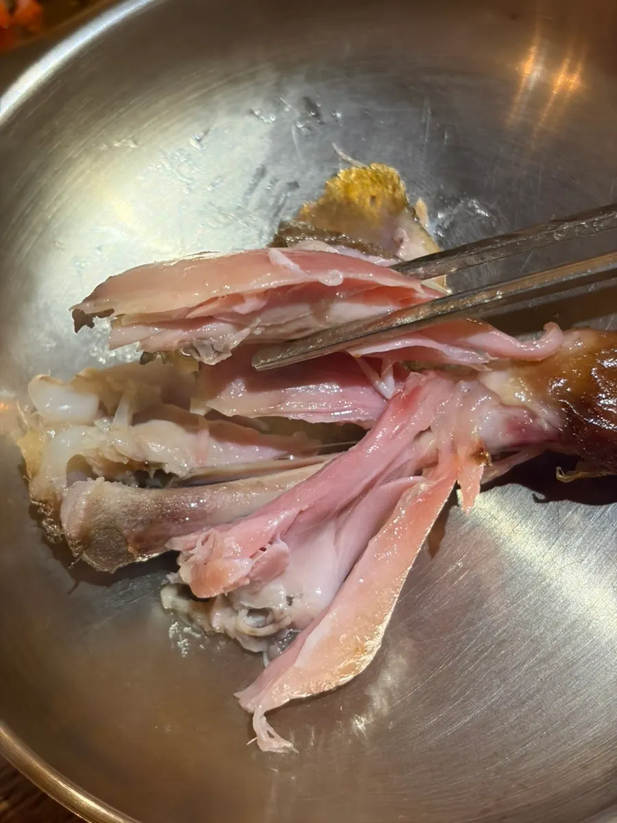 Tender meat pulled from the wood-fired chicken