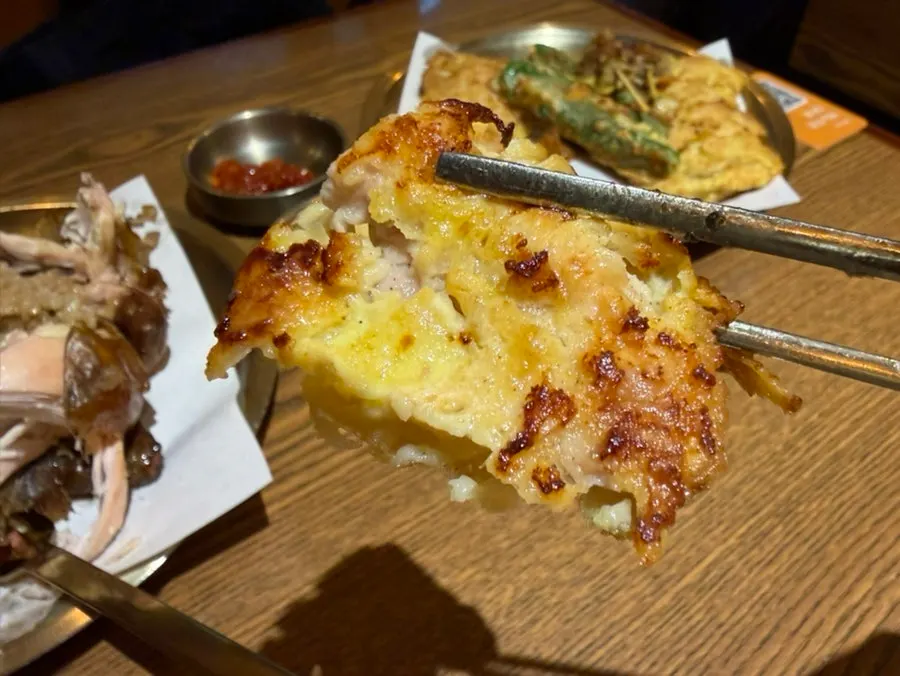 Table with wood-fired chicken and assorted chicken jeon together