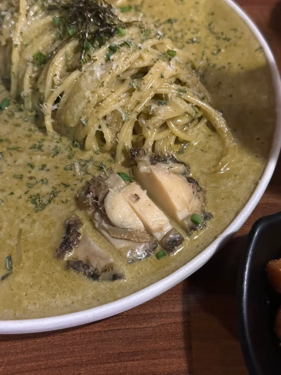 Two sheets of seaweed with dipping sauce