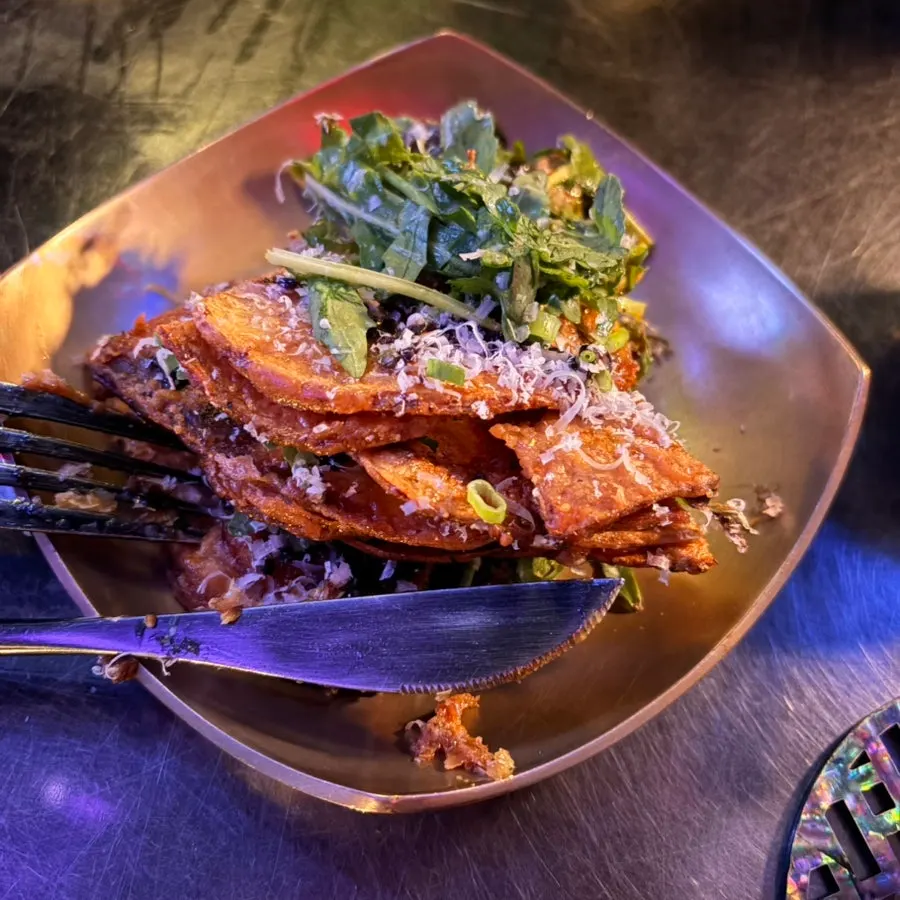 Potato pancake with arugula and egg yolk